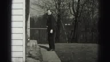 Harrisburg Pennsylvania USA (1975): Man In Black Watching Woman And Two Children