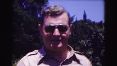 Washington DC-1975: Man in Military Khaki Shirt Raises Aviator Sunglasses