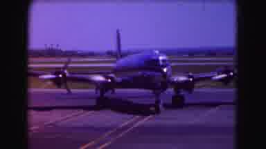 Washington DC (1975): Four Propeller Passenger Plane Moving Slow Turning Airport