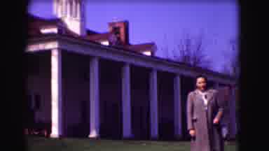 Washington DC (1975): A Woman In An Overcoat Poses By A House With A Steeple
