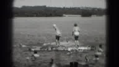 Washington DC (1975): Swimmers In Body Of Water While Two Ladies Compete In A