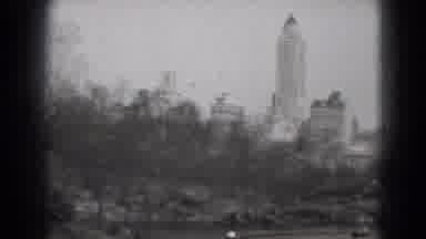 Washington DC (1975): Pan Of A Park With Skyscrapers In The Background And People