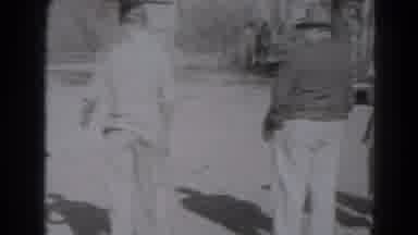Lincoln Nebraska (1975): A Group Of People Standing Around While A Man Puts A Boy