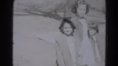 Lincoln Nebraska (1975): Three Young Siblings Walk Holding Hands Smiling Together