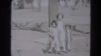 Lincoln Nebraska (1975): Three Children Walk On A Sidewalk Holding Hands Past A