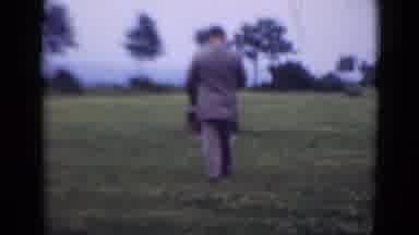 Middletown Pennsylvania (1975): A Man Dressed In A Grey Suit And Tie Walks On A