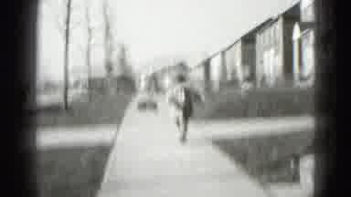 Middletown Pennsylvania (1975): Woman Observes Child Walking On Residential Street
