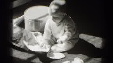Middletown Pennsylvania (1975): Baby Plays With Newspaper On Floor On A Bright