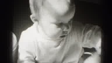 Middletown Pennsylvania (1975): Small Baby Plays With Scrap Of Newspaper And