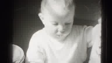 Middletown Pennsylvania (1975): Baby Chewing On A Piece Of Water While Sitting In