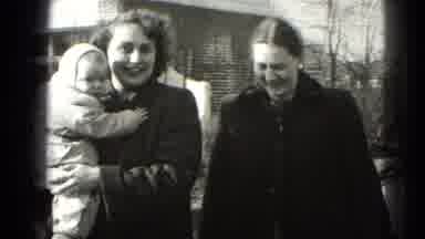 Middletown Pennsylvania (1975): Person Holds Baby Wearing White Hat On A Bright