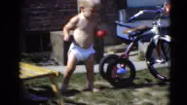 Middletown Pennsylvania (1975): Toddler In Diaper Walks Across The Grass Barefoot
