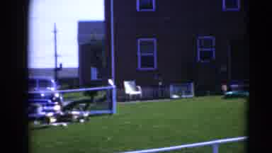 Middletown Pennsylvania (1975): White Chairs And Objects Sitting On Green Grass On