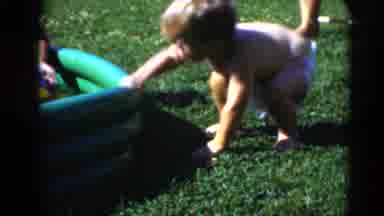 Middletown Pennsylvania (1975): Young Child Wearing Just A Diaper Crawls Across