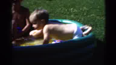 Middletown Pennsylvania (1975): Children Play On An Inflatable Pool While Mother