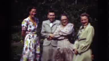 Denmark (1975): Well Dressed Men And Women Stand Together Talking And Laughing