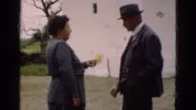 Denmark (1975): Older Man And Woman In Backyard On Overcast Day Friendly With Each