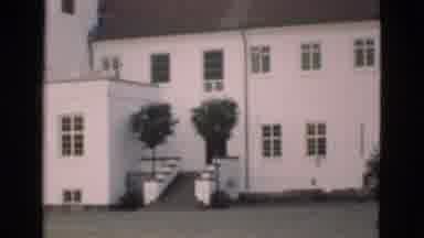 Denmark (1975): Large White Multi-Storey Building Filmed From Across Large Lawn