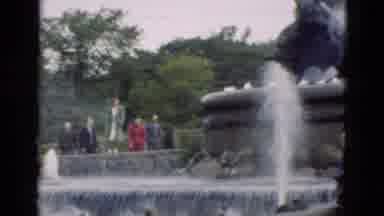 Denmark (1975): People Looking At Black Stone Fountain On A Clear Day