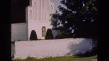 Denmark (1975): Large White Building With Windows And A Fence With An Adult And