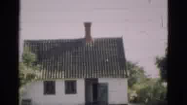 Denmark (1975): Cool House Next To Some Water And Tall Green Bushes