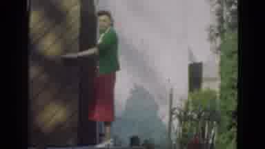 DENMARK-1975: Well Dressed Woman Opens Large Door Speaking to Camera