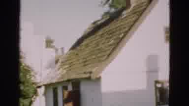 Denmark (1975): View Of White Building With Brown Roof On A Bright Sunny Day