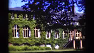 Denmark (1975): View Of White Stone Memorial With Vine Covered Buildings On A