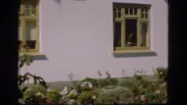 Denmark (1975): Panoramic Shot Of House Followed By Older Couple
