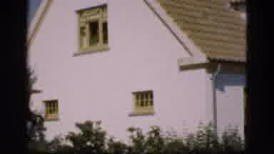 DENMARK-1975: Two Men Relax Outside White House In Vintage 8mm Footage