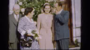 Denmark-1975: Four People in Formal Attire with Flowers Outside Building
