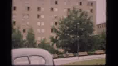 Denmark (1975): Man Walks In Front Of Old Car As He Walks Towards People