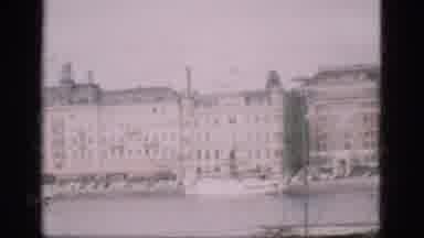 Denmark (1975): There Are Many Huge Building By The Water In The Front Of Them