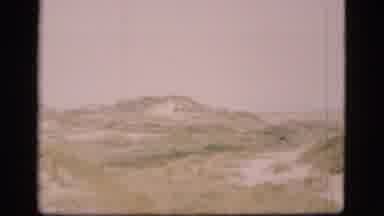 Denmark (1975): The Camera Pans Across The Grassy Hills That Dot The Landscape