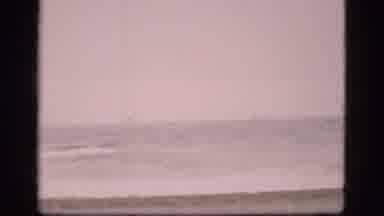 Denmark (1975): View Of Ocean Tide At Empty Beach On A Cloudy Day