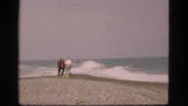 Denmark (1975): Family Standing On Strip Of Land With Waves Colliding In Between