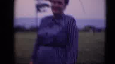 Middletown Pennsylvania (1975): Lady In Blue Stripe Dress Stands Outside In Wind