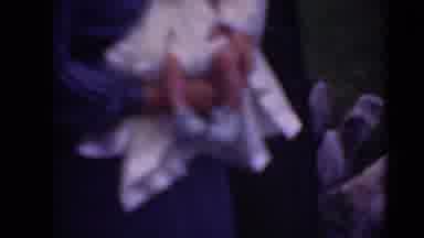 Middletown Pennsylvania (1975): Woman Wearing Blue Dress Holds Baby Wearing White