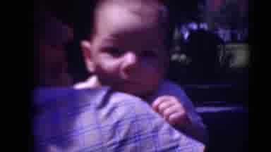 Middletown Pennsylvania (1975): Mother In Plaid Shirt Holds Cooing Baby And Gives