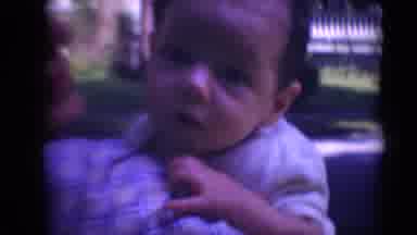MIDDLETOWN PENNSYLVANIA-1975: Little Baby Looks Around As Mother Holds Him Up