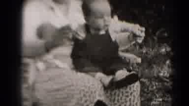 Middletown Pennsylvania (1975): Baby Leaning Forward On Mother's Lap To Reach For