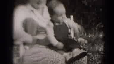 Middletown Pennsylvania-1975: Mother Sits With Baby In Her Lap As Baby Wiggles