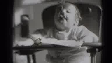 Middletown Pennsylvania (1975): A Baby Sitting In It's High Chair Eating Food