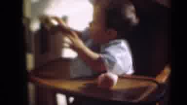 Middletown Pennsylvania (1975): Curious Young Baby Sitting In A High Chair Playing