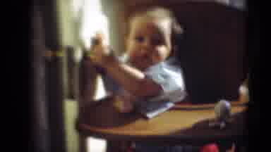 Middletown Pennsylvania (1975): A Baby Sitting On A High Chair And Playing With