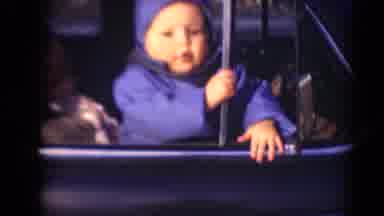 Middletown Pennsylvania (1975): Young Infant In A Blue Thick Coat Looking Out Of A