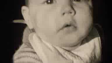 Middletown Pennsylvania (1975): Baby Looking At Camera And Looking Back Behind At