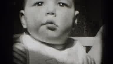 Middletown Pennsylvania (1975): Baby In A Small Crib Looking Directly At The