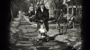 Middletown Pennsylvania (1975): Woman In Fur Coat Walks Her Baby Down A Sidewalk