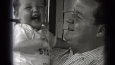 Middletown Pennsylvania (1975): A Man Holding And Playing With His Baby